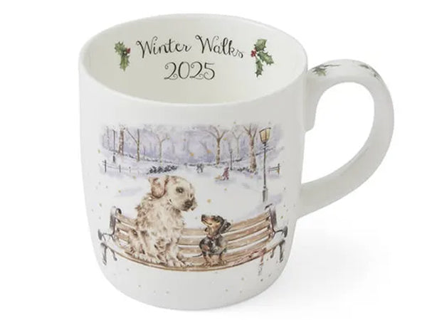 white mug with illustration of dogs on a park bench in the winter