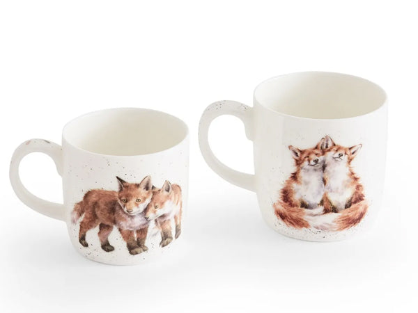 Two white speckled ceramic mugs featuring watercolor illustrations of foxes, shown on a clean white background.