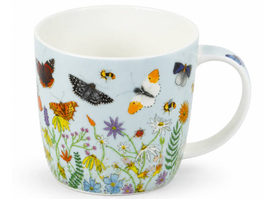 A white ceramic mug featuring a detailed illustration of various butterflies and wildflowers on a pale blue background, set against a plain white studio backdrop.