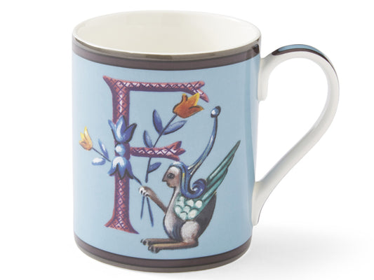  Gracefully adorned with a stylish 'F' initial, this elegant blue mug features a captivating scene of a curious creature cradling vibrant blooms. Complete with a matching blue handle