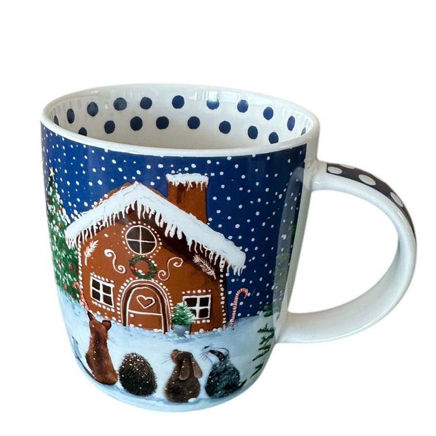 Mug with a gingerbread house design on a snowy background