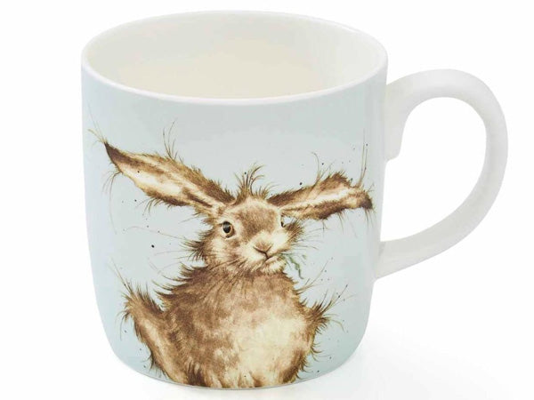 A white ceramic mug featuring a detailed illustration of a brown hare with long ears on a pale blue background, shown against a white studio backdrop.