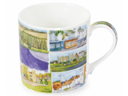 A white ceramic mug featuring a colorful printed collage of landscape and architectural scenes, including green fields, a purple river, and buildings, shown on a plain white background.