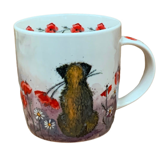 The Alex Clark mug showcases a delightful Border Terrier dog appreciating the view while holding a Poppy in its mouth. Additionally, the mug is adorned with poppy flower illustrations around the inside rim and down the handle, adding to its charm and appeal.