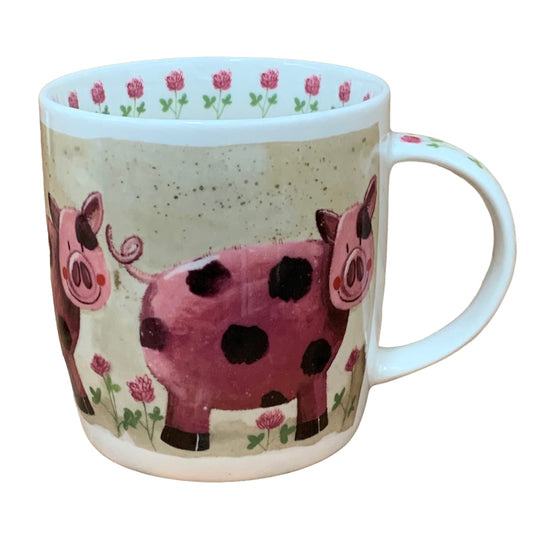 The Alex Clark mug showcases a pig named Pearl standing in her meadow of flowers. Enhancing its charm, the mug features pink flower illustrations around the inside rim and down the handle.