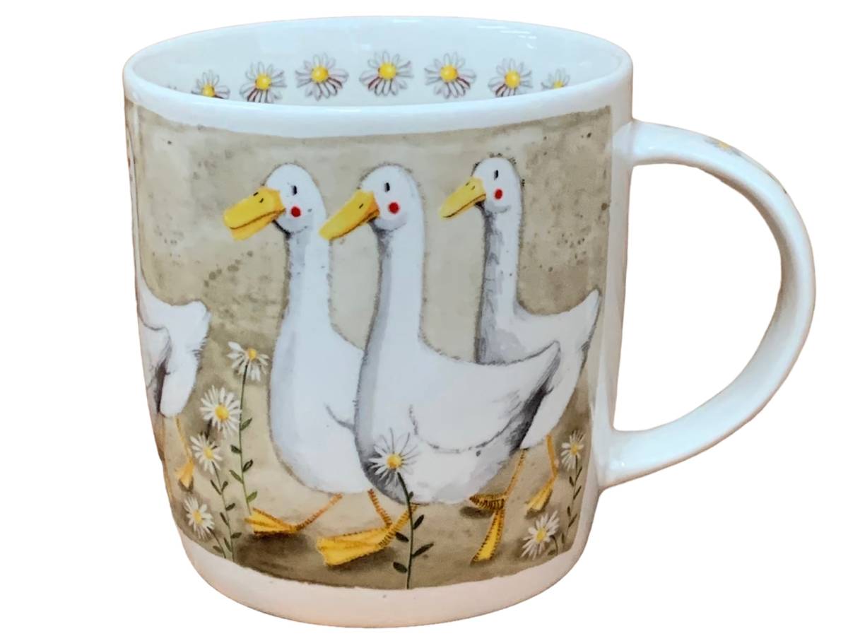 A white ceramic mug featuring a printed illustration of three white geese walking among small white daisies on a textured beige background.