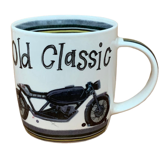 The Alex Clark mug showcases an old classic bike with the words "old classic" written on the top. Enhancing its design, the mug includes bike track illustrations around the inside rim and down the handle.