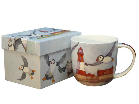 The "Puffins & a Lighthouse" Bone China Mug, crafted by Emma Ball, comes in a splendid presentation box, perfect for gifting or as a delightful treat for oneself.