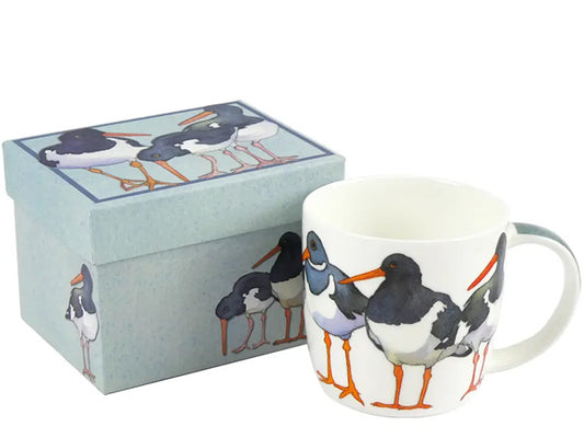 Crafted by Emma Ball, this Fine Bone China mug adorned with Oystercatchers is tastefully showcased in a captivating gift box, making it the ideal gift for a special someone.