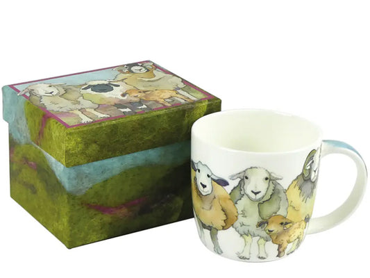 Crafted by Emma Ball, this Fine Bone China mug featuring Felted Sheep is elegantly presented in a captivating gift box, making it the ideal gift for a special someone.