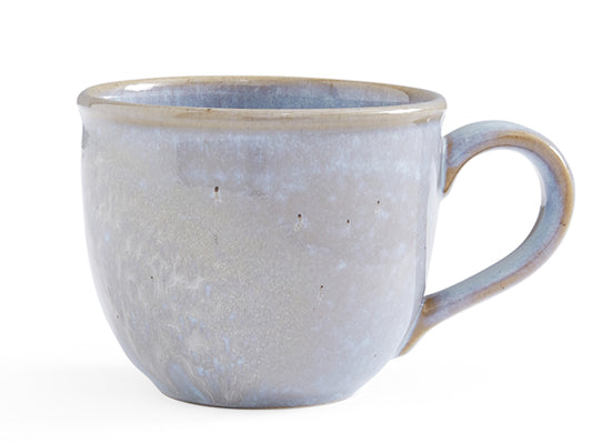 Behold the Aquamarine Mug, skillfully crafted in Portugal from reclaimed clay, blending genuine materials with artisanal mastery. Each stoneware mug is enveloped in a reactive glaze, showcasing captivating pale blue tones and captivating patterns, rendering it truly one-of-a-kind. Whether cherished individually or combined with the Rose Quartz and Amethyst hues from the Minerals collection, this Aquamarine mug infuses your everyday moments with a dash of natural elegance and unparalleled flair.