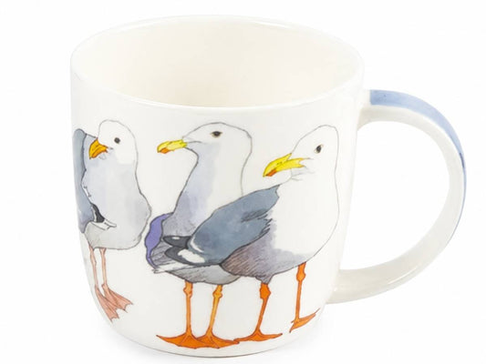 A white ceramic mug featuring a painted illustration of three seagulls with gray bodies, white heads, yellow beaks, and orange legs, shown on a plain white background.
