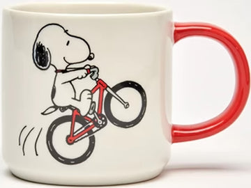Featuring a whimsical illustration, this Magpie Peanuts Snoopy mug captures the playful spirit of Snoopy riding a vibrant red bike. The reverse side boldly declares in black letters, 'Born to Ride,' adding a touch of adventurous flair to your sipping experience.