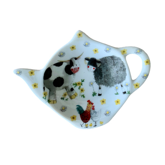 The Alex Clark teabag tidy features a charming illustration showcasing an assortment of friendly farm animals. Completing the set, the same endearing imagery decorates matching teapot and mugs within the illustration.