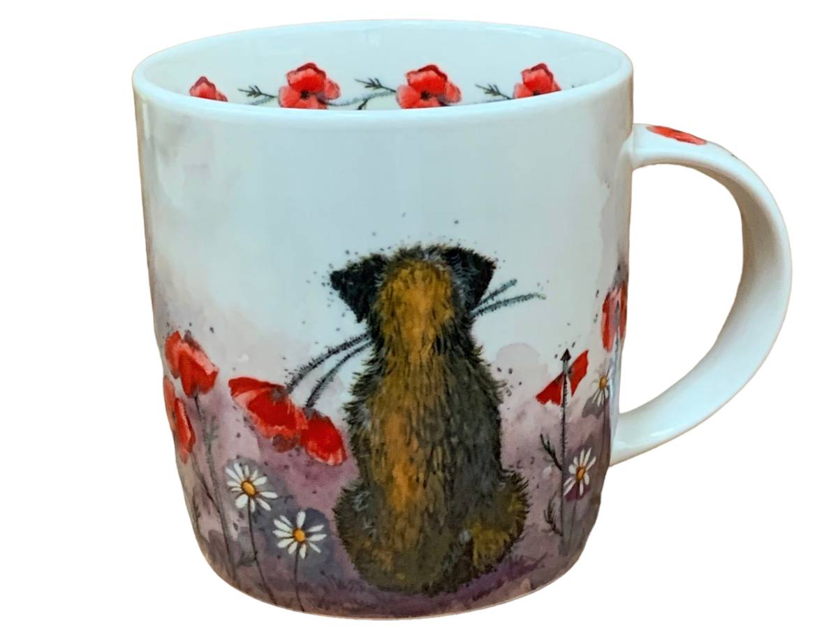 A white ceramic mug featuring a whimsical illustration of a brown and black cat sitting amidst red poppies and small white daisies on a purple-toned background.