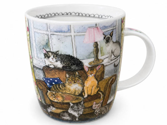A white ceramic mug featuring a detailed illustration of various cats lounging in a cozy living room with a window, lamp, and armchair.