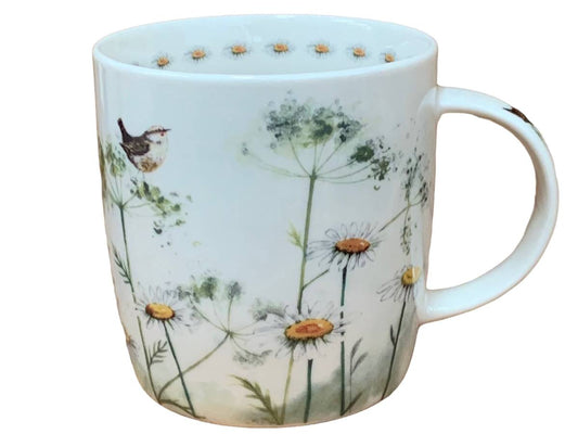 A white ceramic mug decorated with a delicate illustration of daisies, green wildflowers, a small bird, and a dotted border around the inner rim, shown against a plain white background.