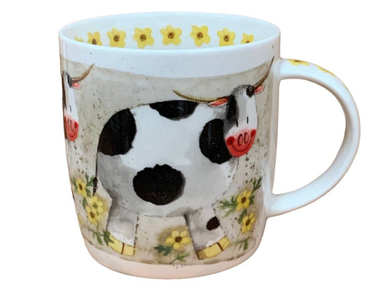 A white ceramic mug featuring a whimsical illustration of a black and white cow with red accents, surrounded by yellow flowers on a textured beige background.