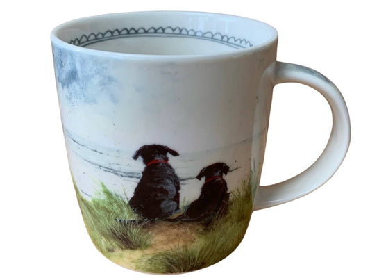 Mug with a design of two dogs sitting on grass looking out to sea and a blue sky.