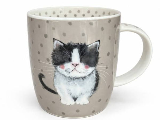 A ceramic mug with a gray and white polka dot pattern, featuring a detailed illustration of a black and white kitten on the front, set against a plain white background.