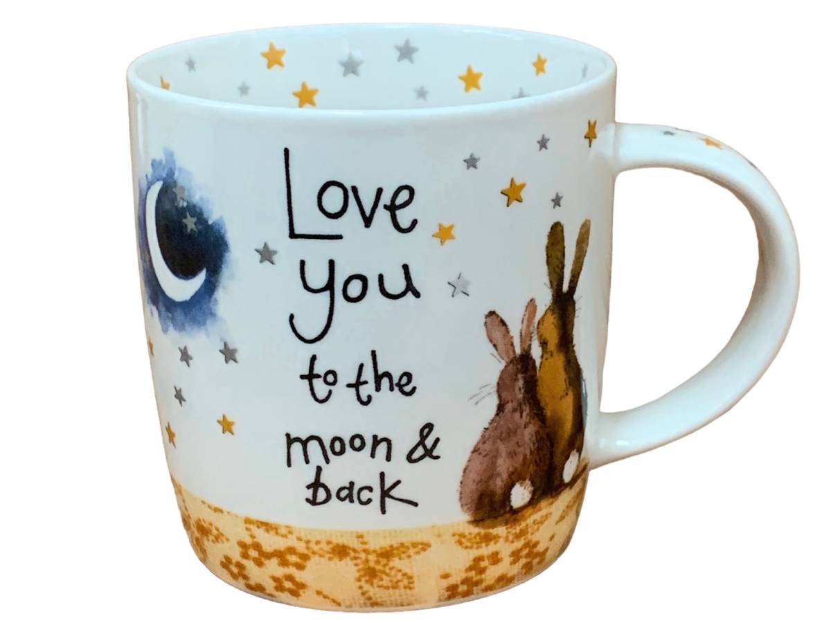 White Alex Clark mug illustrated with two rabbits, a crescent moon and gold and grey stars, featuring the words “Love you to the moon & back.”