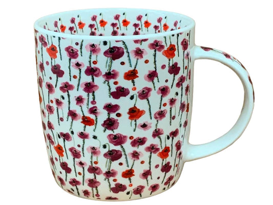 A white ceramic mug decorated with a dense pattern of red, pink, and purple poppy flowers with green stems, shown against a plain white background.