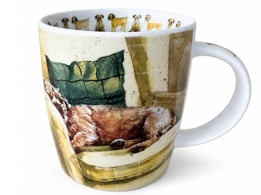A white ceramic mug featuring a detailed illustration of a sleeping dog on a cushion, with a row of small dog portraits printed around the inner rim.