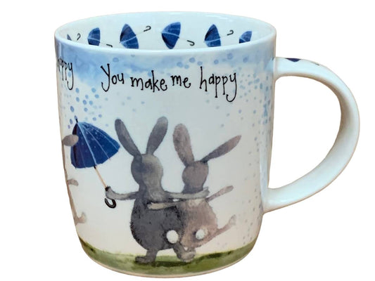 This Alex Clark mug showcases two delightful and cheerful bunny rabbits alongside the words "you make me happy" along the top of the mug. Additionally, the mug features a charming umbrella illustration around the inside rim and illustrations down the handle, adding to its whimsical appeal.