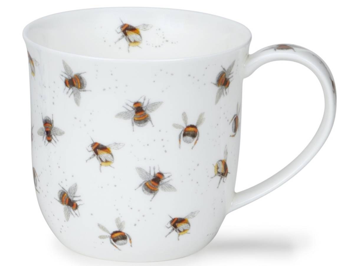 A white ceramic mug decorated with a pattern of flying honeybees and small gray speckles, shown against a plain white background.