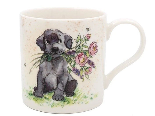 Paper Shed Puppy Mug by Lesser & Pavey showing a fluffy puppy holding fresh flowers, made from lightweight durable china, perfect for dog lovers and gift giving