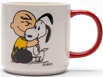 showcasing a cozy illustration of Charlie Brown embracing Snoopy. The red hue of the handle seamlessly complements the warm sentiment of the mug. On the back, playful black text declares, "Happiness is a Warm Puppy,"