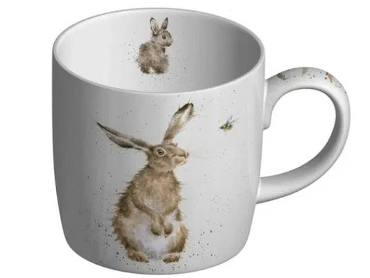 A white ceramic mug featuring a watercolor-style illustration of a brown hare and a small bee, with a smaller hare printed inside the mug.
