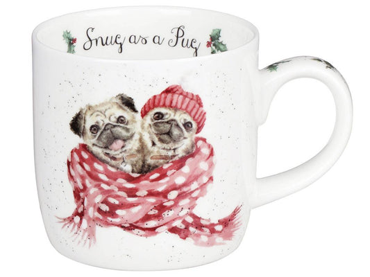 A white ceramic mug featuring a watercolor illustration of two pug dogs wrapped in a red and white polka-dot scarf and matching red knit hat. The top rim of the mug has the phrase 'Snug as a Pug' written in black script with small holly accents.