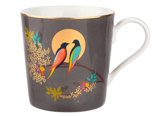 Presenting the exquisite Sara Miller London Chelsea Mug in Dark Grey, a delightful porcelain creation. Embellished with captivating exotic birds and intricate gold details set against a dark grey backdrop,
