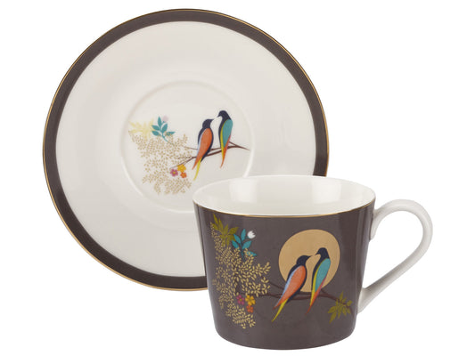 This teacup and saucer from the Chelsea range offers a modern twist on classic English porcelain tableware. Inspired by ancient Asian practices that have influenced British culture for centuries, Sara Miller's designs take on a contemporary form. Featuring a dark grey background adorned with exotic birds and gold embellishments, 